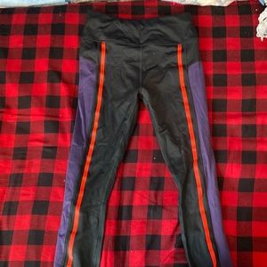 Black and purple leggings with pink reflective line